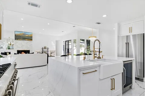 a large kitchen with stainless steel appliances lots of counter space and breakfast area