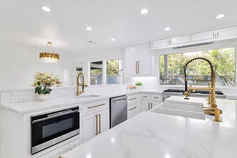 a kitchen with a stove a sink and a refrigerator