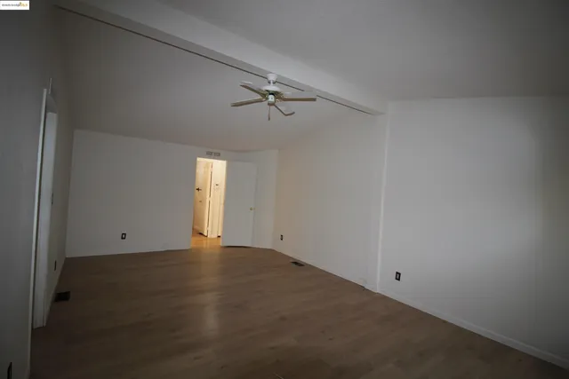 an empty room with windows and closet