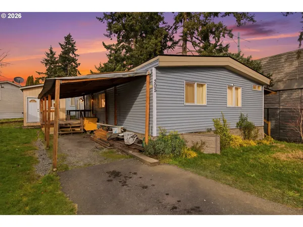 a backyard of a house with table and chairs
