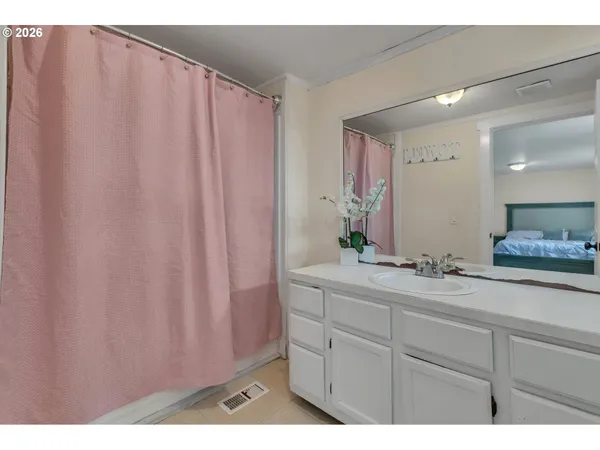 a bathroom with a double vanity sink and a mirror
