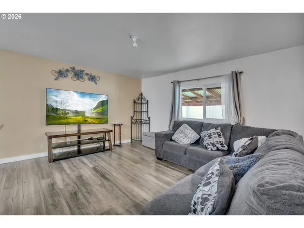 a bedroom with furniture and a flat screen tv