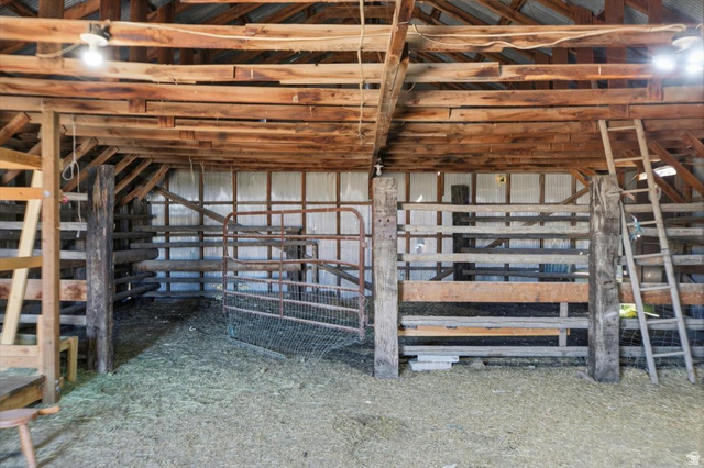 1634 West Arimo Road Arimo, ID 83214 - Photo 57 of 89 Spacious barn interior featuring exposed wood beams and a slatted wood ceiling
