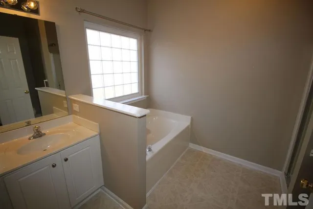 a bathroom with a sink a mirror and a shower