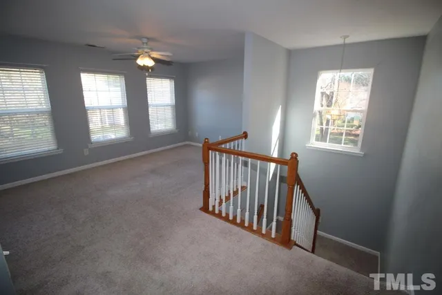 a view of an empty room with windows