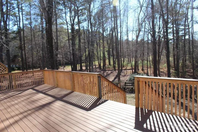 a front view of a house with a wooden deck