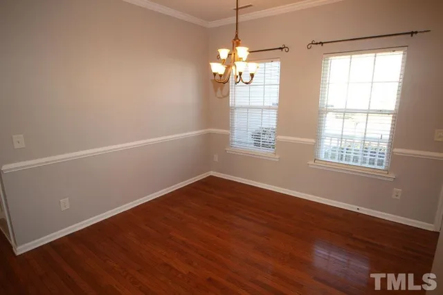 a view of a kitchen with wooden floor and a space