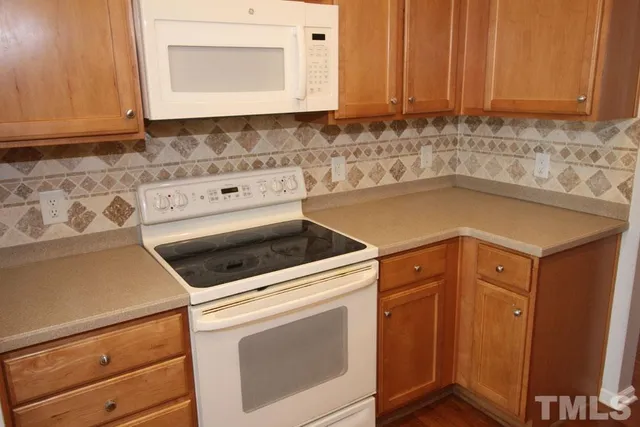 a kitchen with stainless steel appliances a refrigerator and a sink