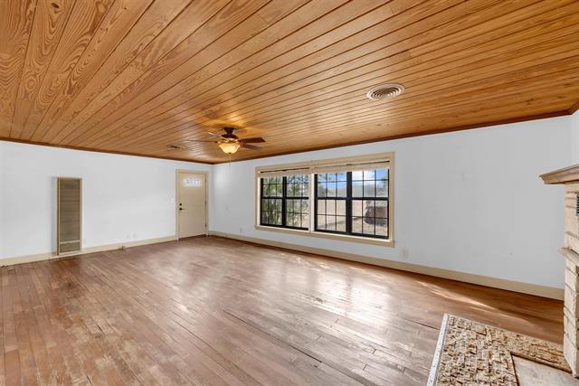 8164 Ranch Road 261 Buchanan Dam, TX 78609 - Photo 14 of 20 a view of an empty room with wooden floor and a window