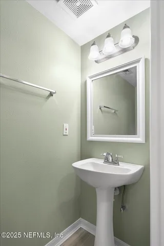 a bathroom with a sink a mirror and a toilet