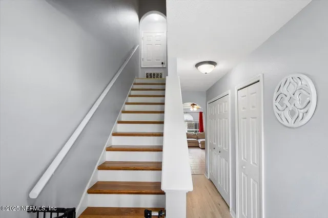 a view of entryway with stairs and wooden floor