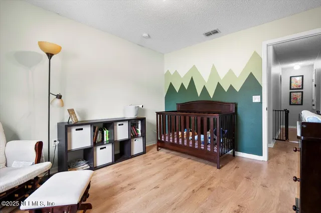 a bedroom with furniture and a wooden floor