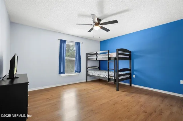 a bedroom with bed and a window