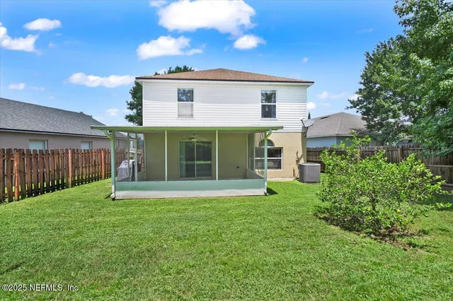 a view of a house with a yard and sitting area