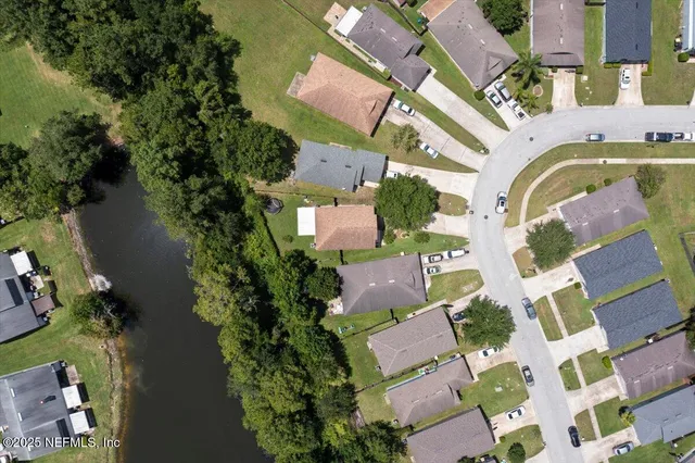 an aerial view of residential house with outdoor space and swimming pool