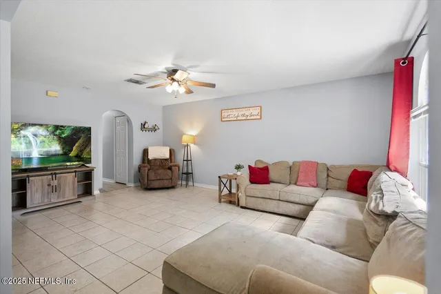 a living room with furniture and a flat screen tv