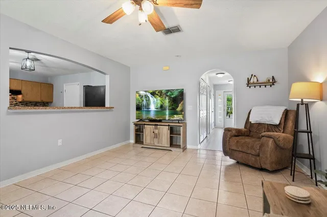 a living room with furniture and a flat screen tv