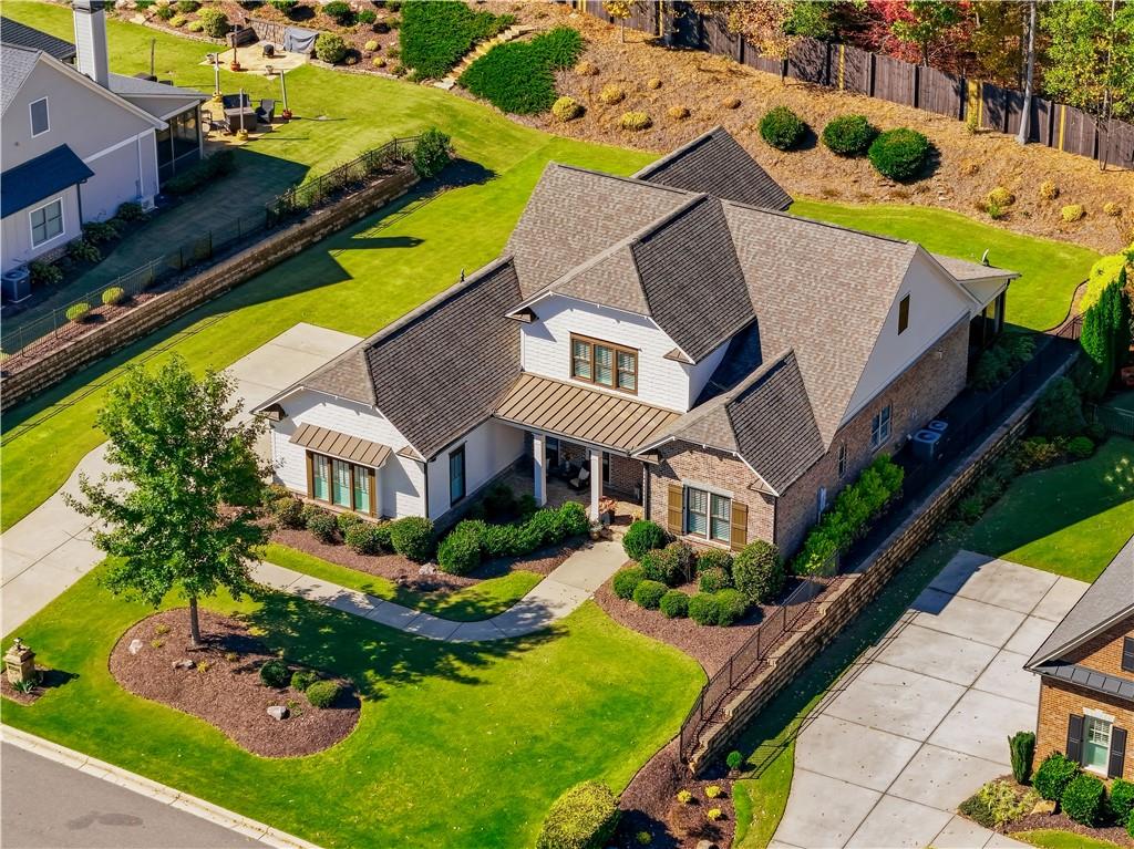 an aerial view of a house with a swimming pool patio and outdoor seating