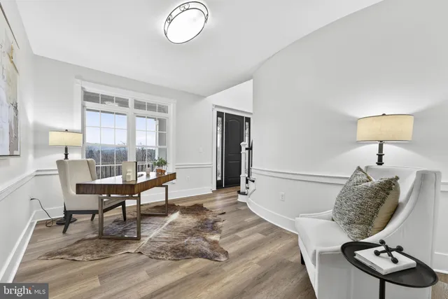 a living room with granite countertop kitchen island stainless steel appliances and a counter space