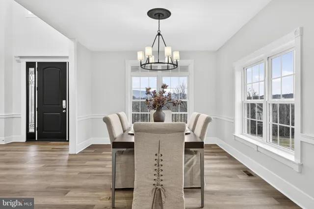 a kitchen with stainless steel appliances granite countertop a sink a stove and a wooden floors