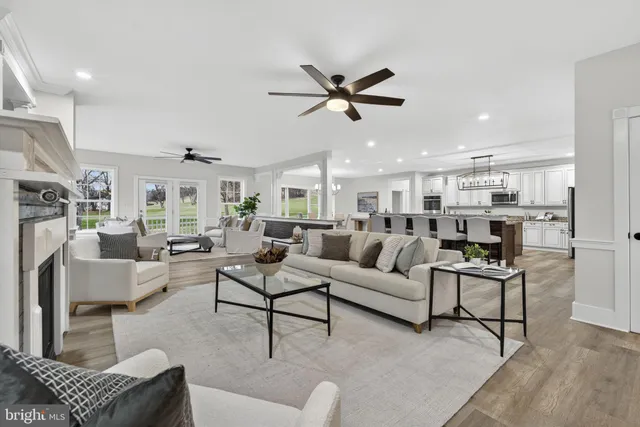 a living room with furniture and a chandelier