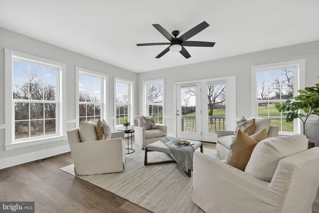 a living room with a stove and a refrigerator