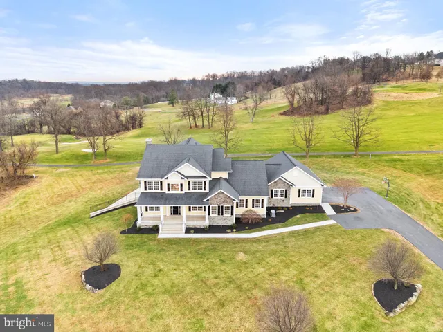a front view of a house with a yard table and chairs