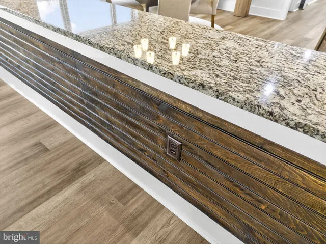 an empty room with chandelier fan and windows