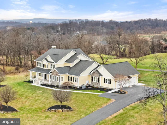 a view of a hallway with wooden floor and stairs
