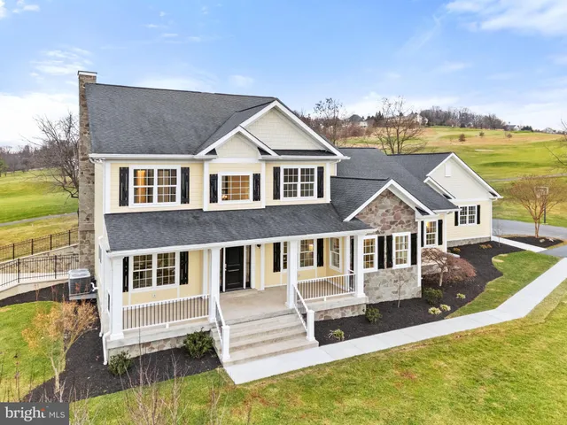a living room with furniture a window and a potted plant