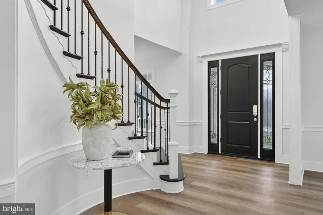 a dining room with furniture a chandelier and wooden floor