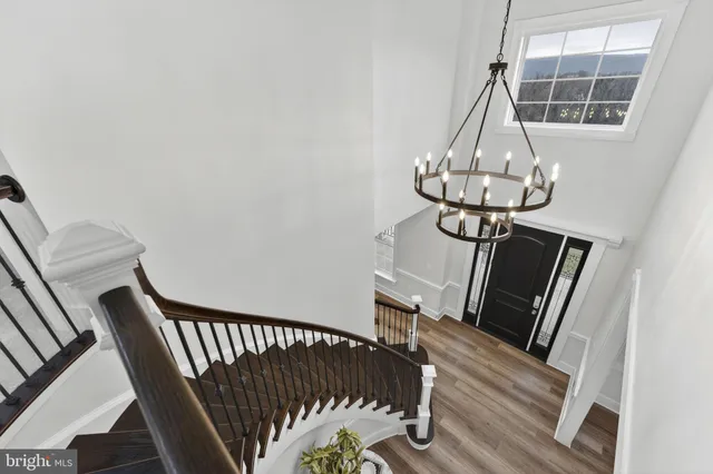 a dining room with furniture a chandelier and wooden floor