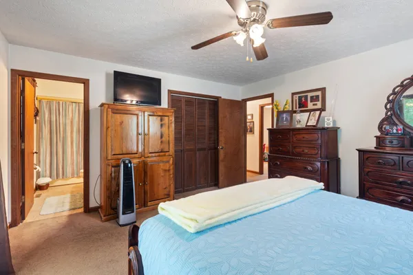 a bed room with a bed and a television