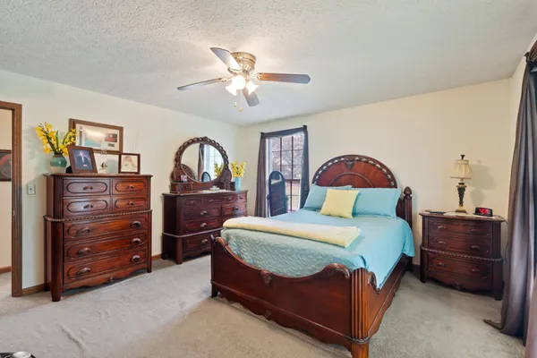 a bedroom with a bed and a dresser