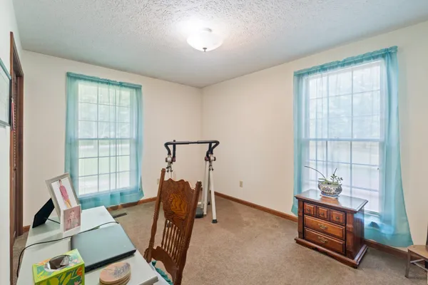 a bathroom with a granite countertop sink mirror and toilet