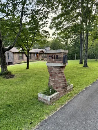 a view of a green field with lots of bushes