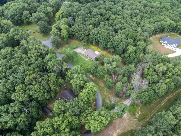 a view of a house with pool and chairs