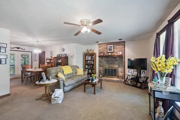 a living room with furniture a fireplace and a flat screen tv