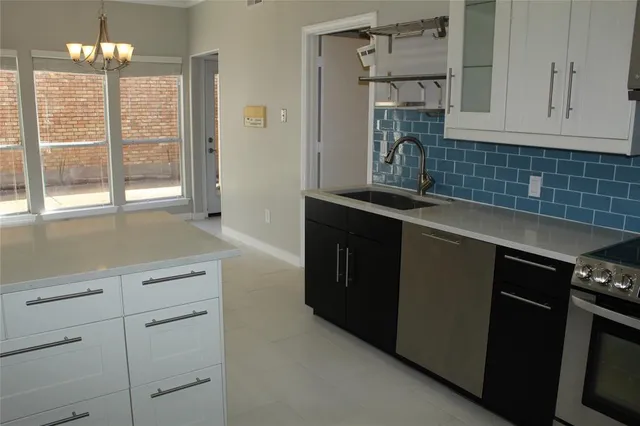 a kitchen with a sink and cabinets