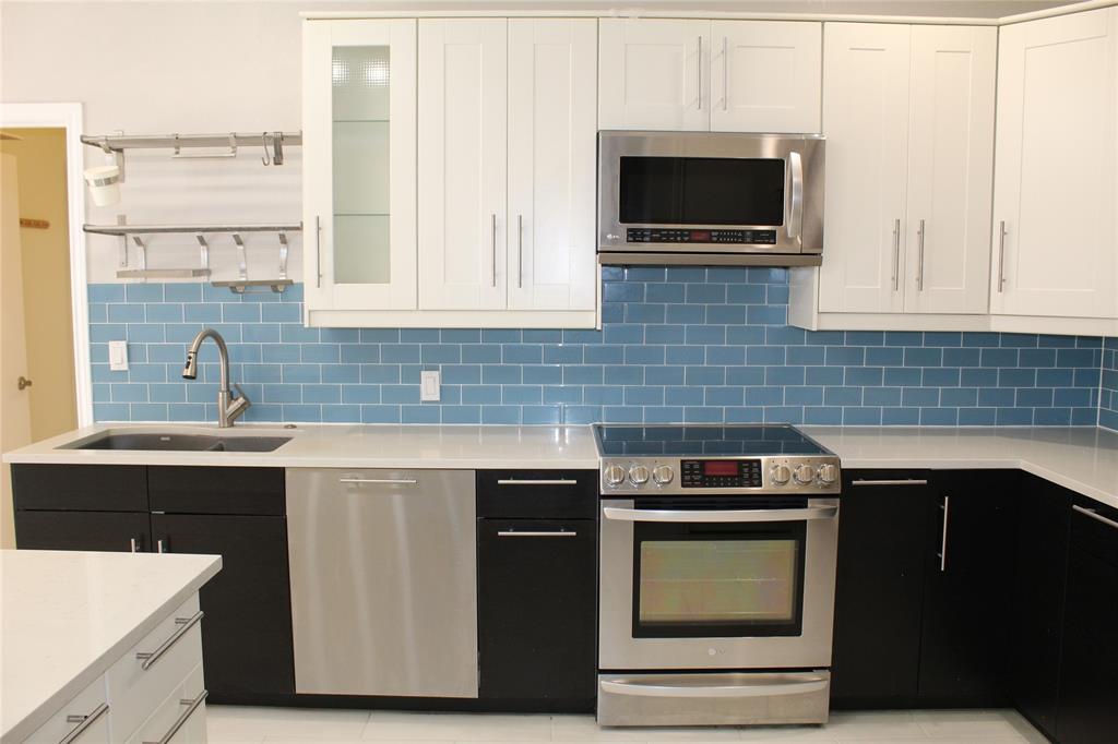 4033 Cornish Place Plano, TX 75093 - Photo 7 of 23 a kitchen with stainless steel appliances a stove sink and microwave