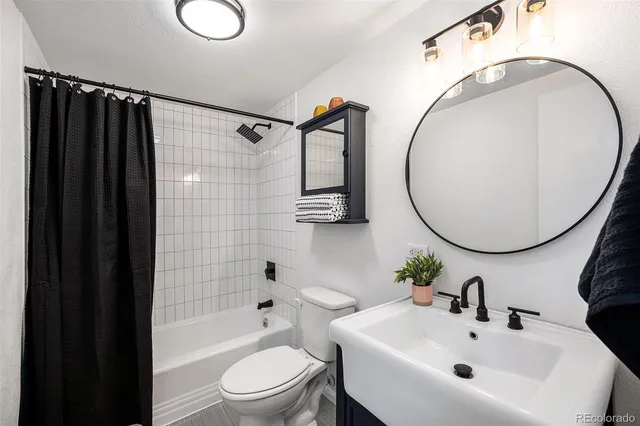 a view of a workspace with furniture and wooden floor