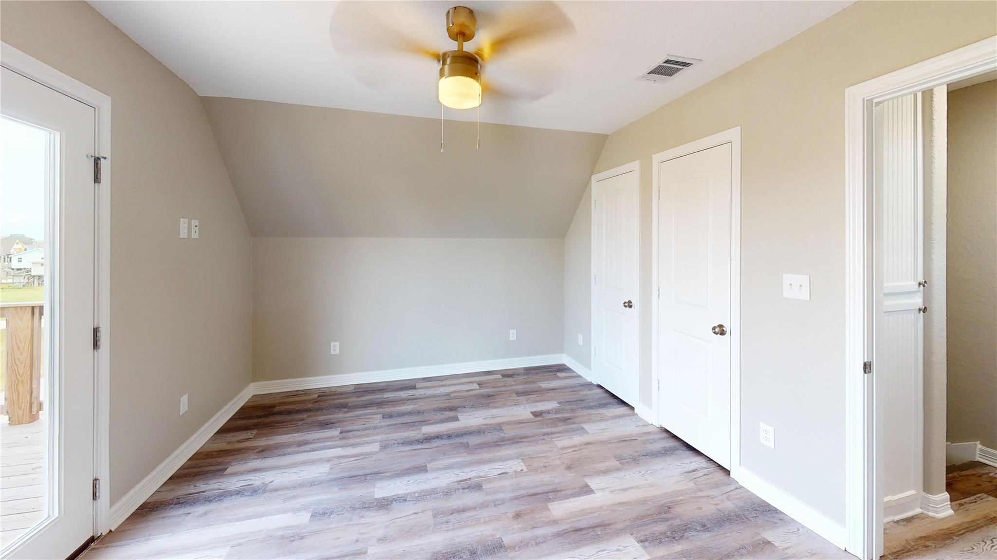 511 Caisson Street Surfside Beach, TX 77541 - Photo 22 of 33 a view of an empty room with wooden floor