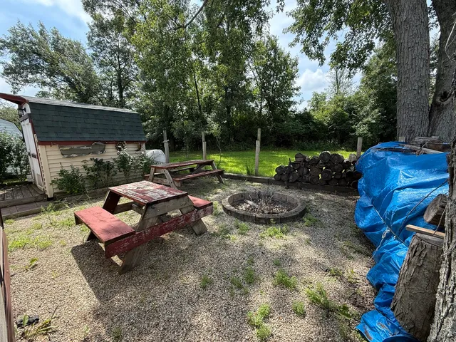 a view of a backyard with furniture and garden