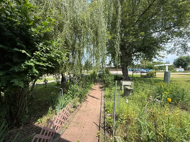 a view of a backyard with sitting area