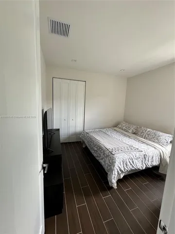 a bedroom with a bed and a walk in closet