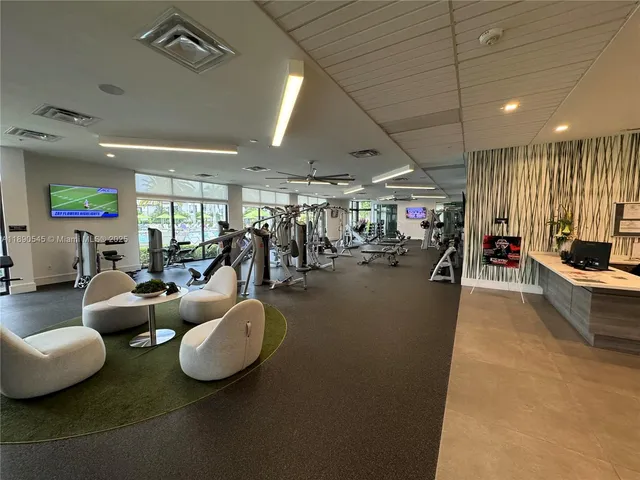 a living room with lots of furniture and a chandelier