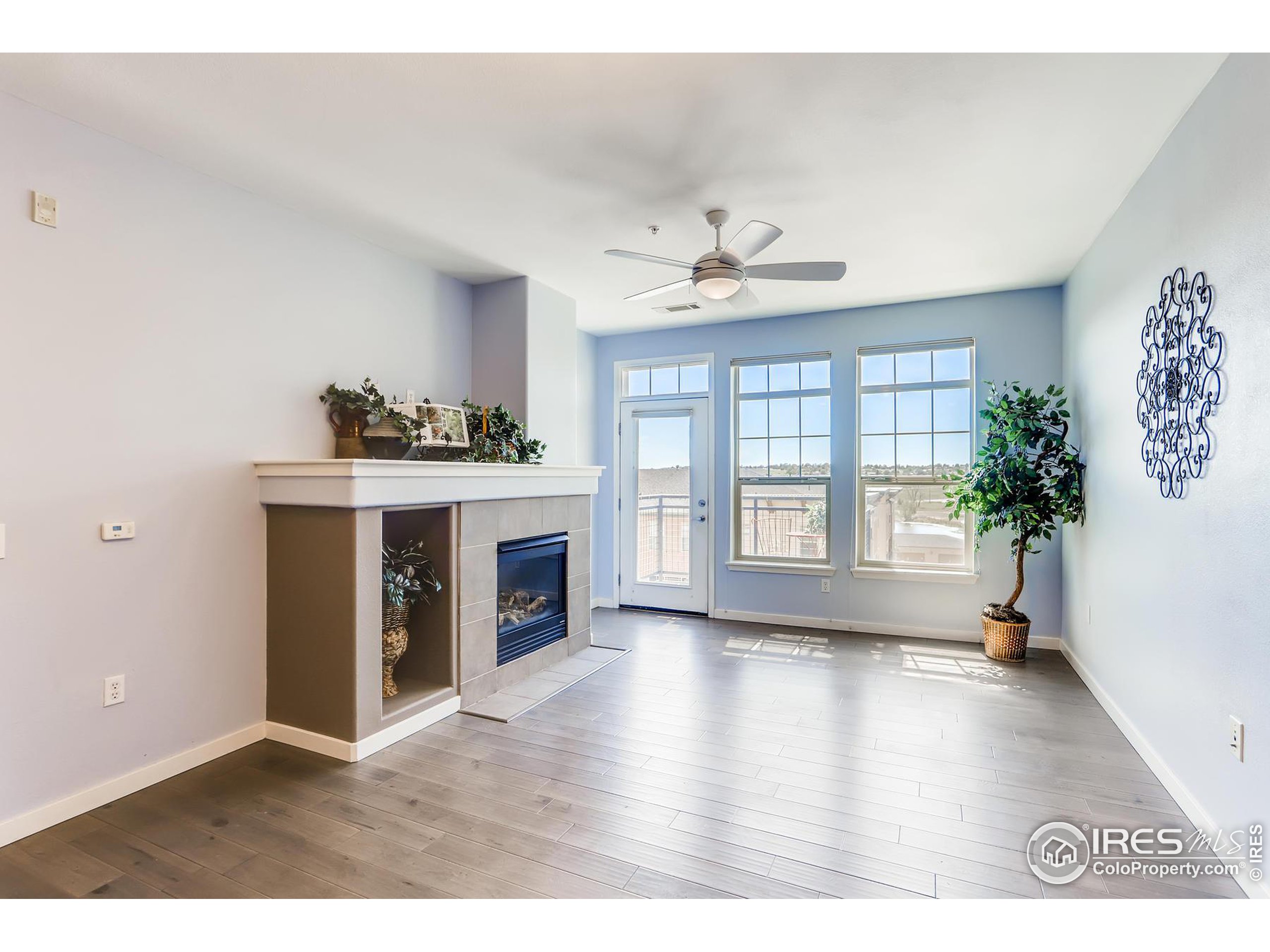 13456 Via Varra, Unit 315 Broomfield, CO 80020 - Photo 1 of 22 a living room with furniture and a fireplace