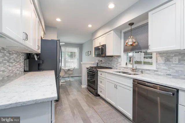 a living room with furniture a rug and a window