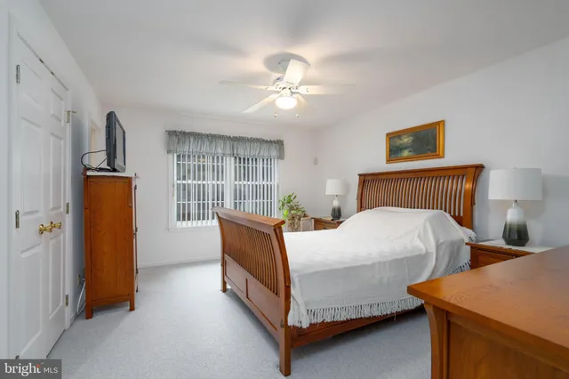 a view of a bedroom with a bed and a flat screen tv