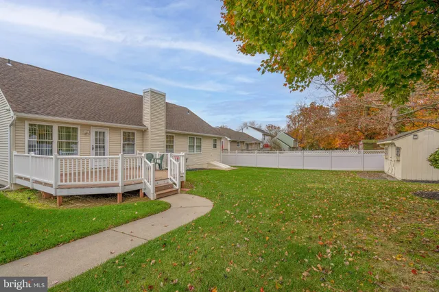 a view of a house with a deck and furniture